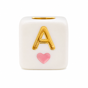 White cube bead with gold letter A and pink heart charm for personalized jewelry.