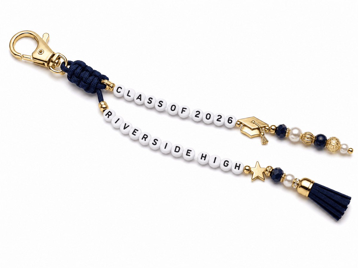The Personalized Graduation Keychain - Custom School Name and Year features two beaded strings “CLASS OF 2026” 